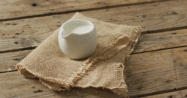 Rustic Ceramic Milk Jug on Wooden Table and Burlap Cloth - Download Free Stock Images Pikwizard.com