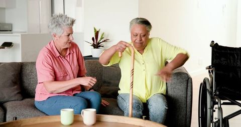 Senior Lesbian Couple Enjoying Coffee with Supportive Gesture