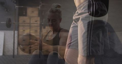 Athletic Woman Performing Medicine Ball Sit-Ups in Gym Environment