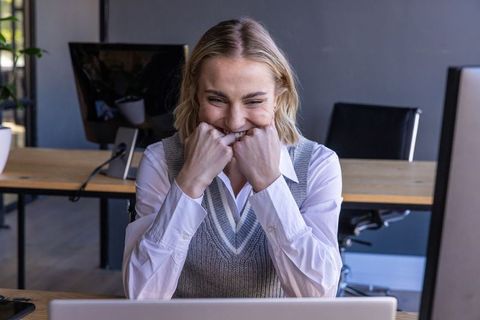 Excited Businesswoman Anticipating Success at Office Workspace