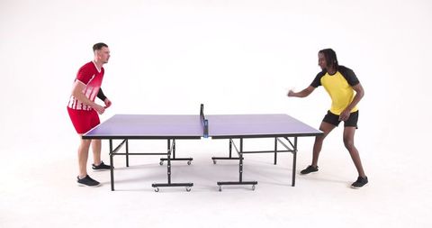 Two Male Athletes Intensely Competing in Table Tennis