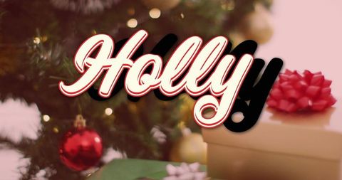 Festive holiday scene with bold graphic 'Holly' text layered over Christmas tree and presents. Stock photo perfect for holiday promotions, greeting cards, digital marketing campaigns and seasonal advertisements, capturing Christmas celebration and decoration spirit.