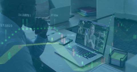 Office Workspace Featuring Virtual Meeting with Financial Data Overlay