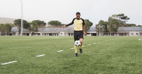 Soccer Player Practicing Ball Control on Field