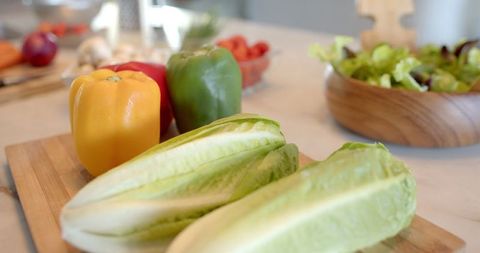 Fresh Romaine and Colorful Vegetables on Wood Board