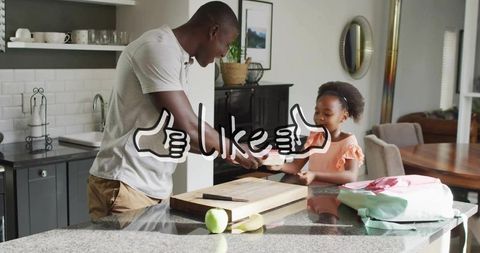 Father handing breakfast plate to daughter at granite kitchen island with backpack nearby