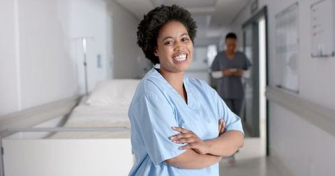 Confident African American Nurse Smiling in a Hospital Corridor - Download Free Stock Images Pikwizard.com