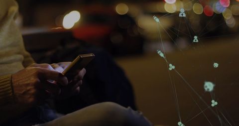 Man using smartphone in city with technology network background