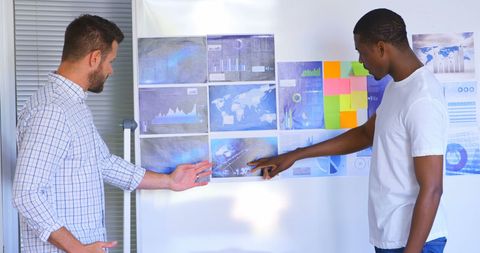 Young professionals analyzing business graphs in modern office