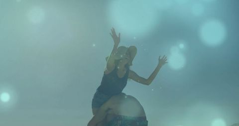 Playful Couple Piggyback Ride in Vibrant Studio with Dreamy Filters