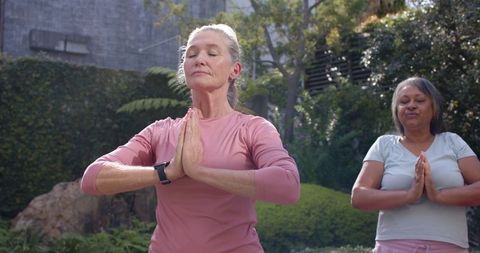 Diverse Women Meditating Outdoors in Garden Fostering Wellness and Mindfulness