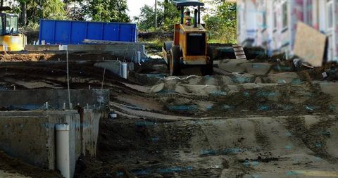Operating road roller compactor at urban construction site
