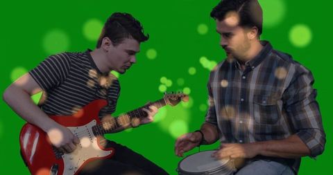 Duo musicians performing with electric guitar and hand drum