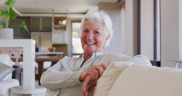 Happy senior woman relaxing on couch at home - Download Free Stock Images Pikwizard.com