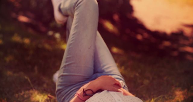 Person Relaxing Outdoors on Green Grass on Sunny Day - Download Free Stock Images Pikwizard.com