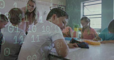 Elementary students writing at classroom table with digital binary code overlay