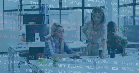 Women Collaborating in Modern Office with Stock Market Analysis