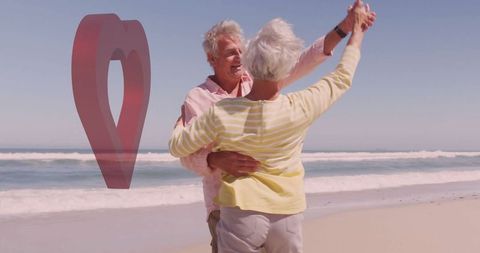 Senior Couple Embracing and Dancing on Sunny Beach
