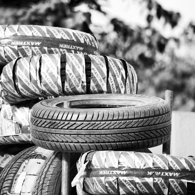 New Car Tires Stacked in Outdoor Display - Download Free Stock Photos Pikwizard.com
