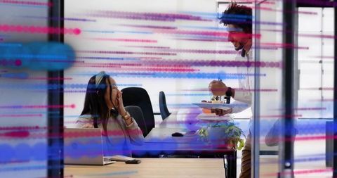 Coworkers sharing snack and laughing in modern open-plan office with glass overlay