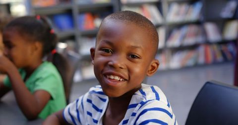 Smiling African American Schoolboy Studying in Classroom