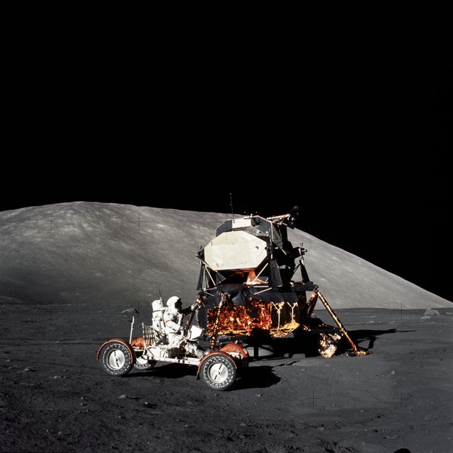 AS17-147-22527 (11 Dec. 1972) --- Astronaut Eugene A. Cernan, Apollo 17 mission commander, makes a short checkout of the Lunar Roving Vehicle during the early part of the first Apollo 17 extravehicular activity (EVA) at the Taurus-Littrow landing site. The Lunar Module is in the background. This photograph was taken by scientist-astronaut Harrison H. Schmitt, lunar module pilot.