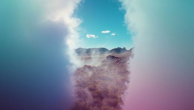 Surreal rocky plateau scene with pastel mist and reflective pool