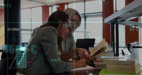 Women collaborating on research in modern library with data charts overlay