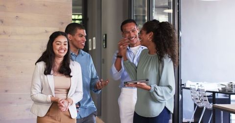 Diverse Team Enjoying Successful Meeting in Modern Office