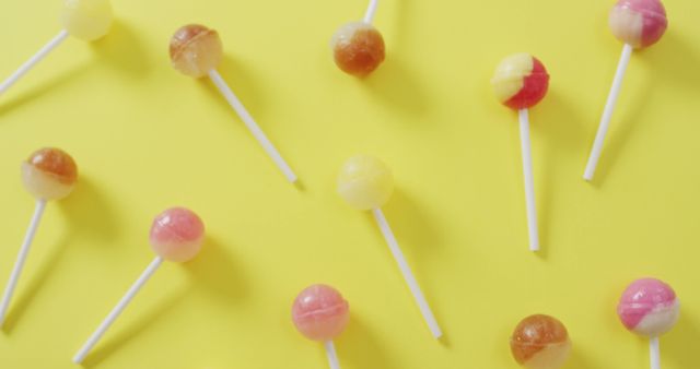 Colorful Assorted Lollipops on Bright Yellow Background - Download Free Stock Images Pikwizard.com