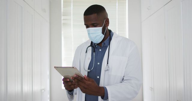 Healthcare Professional Wearing Mask Using Tablet in Medical Facility - Download Free Stock Images Pikwizard.com