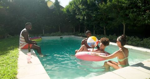 Friends Enjoying a Sunny Day at Backyard Poolside