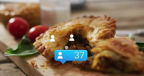 Rustic savory hand pie breaking open on wooden board with social notification bubble