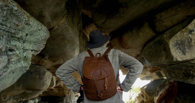 Adventure Traveler Exploring Cave with Backpack and Hat - Download Free Stock Images Pikwizard.com