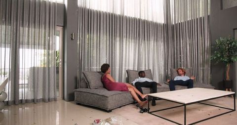Friends Relaxing After Wedding in Modern Lounge Area