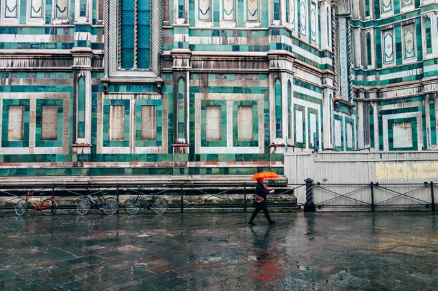 Person Walking with Red Umbrella beside Renaissance Building - Download Free Stock Images Pikwizard.com