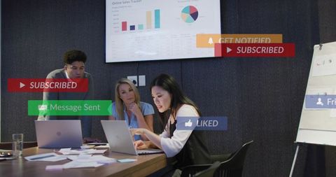Asian businesswoman presenting data on laptop during team meeting with dashboard charts