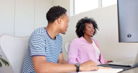 Young Couple Collaborates on Laptop in Modern Home Office