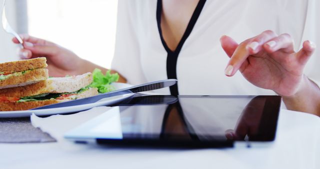 Woman Eating Healthy Sandwich While Using Tablet - Download Free Stock Images Pikwizard.com