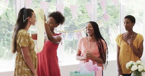 Joyful Friends Celebrating Baby Shower with Gifts and Smiles