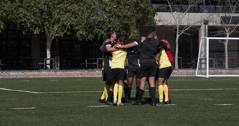 Soccer team unity during pre-game huddle on field