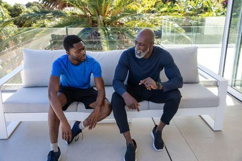 Mentor guiding trainee on terrace relaxing outdoors