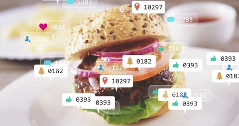 Closeup sesame burger with tomato, red onion, lettuce and social engagement icons