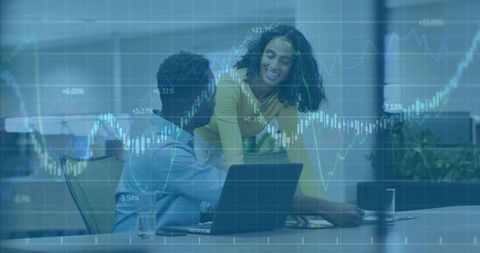 Collaborating on financial charts: office team analyzing data on laptop with overlay