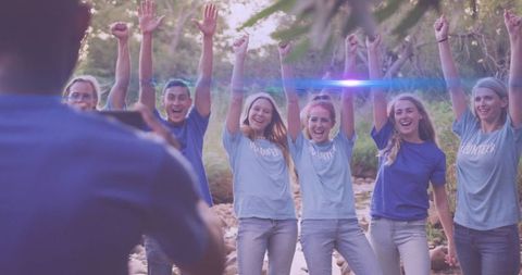 Enthusiastic volunteer group celebrating environmental cleanup