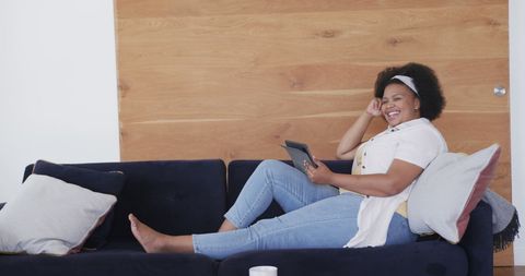 Happy Woman Relaxing with Tablet on Cozy Couch at Home - Download Free Stock Images Pikwizard.com