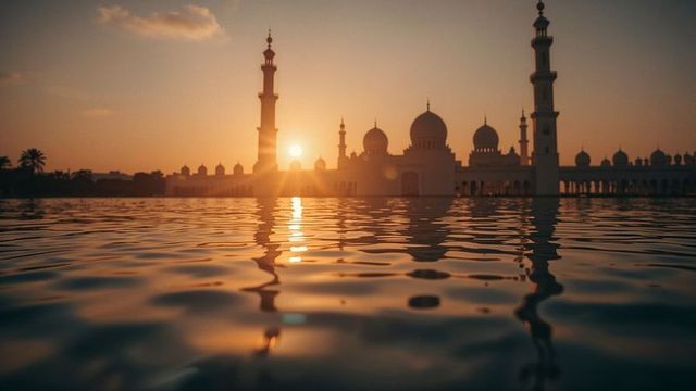 Sunset Silhouette of Mosque Across Tranquil Pool