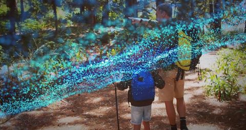 Father and Son Exploring Forest Trail with Digital Energy Vortex