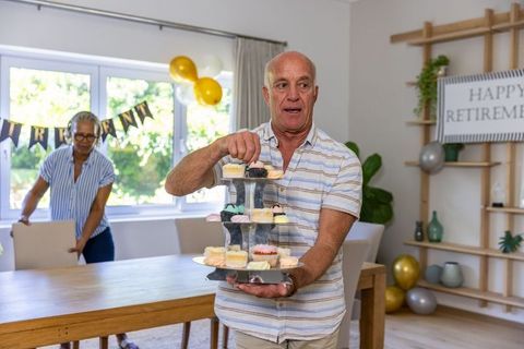 Senior Friends Arranging Retirement Party with Cakes and Decor