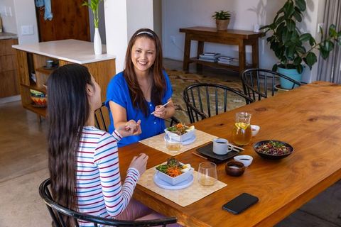 Mother and Daughter Dining Together at Home in Cozy Kitchen